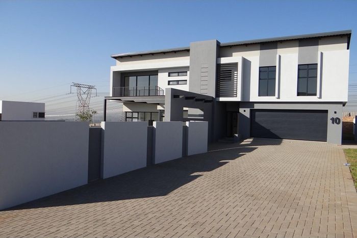 For Sale: House in Midstream Estate with 3 en-suite bedrooms, patio, and garages.