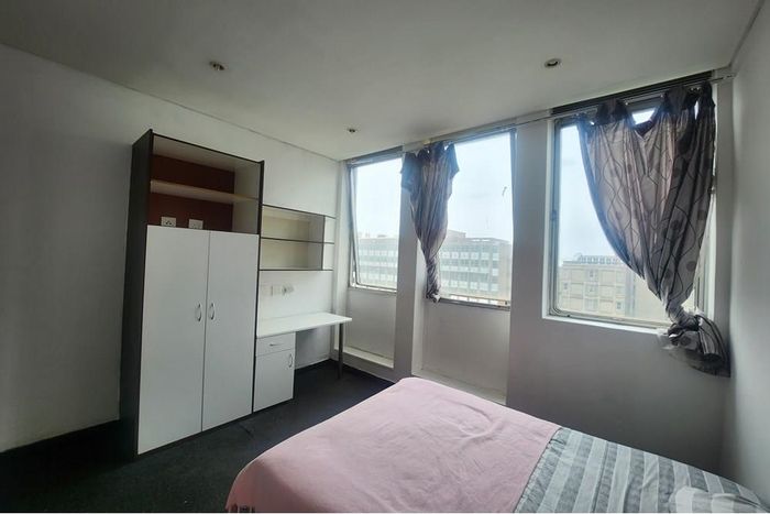 Braamfontein Apartment For Sale: Includes parking bay, storage room, and study areas.
