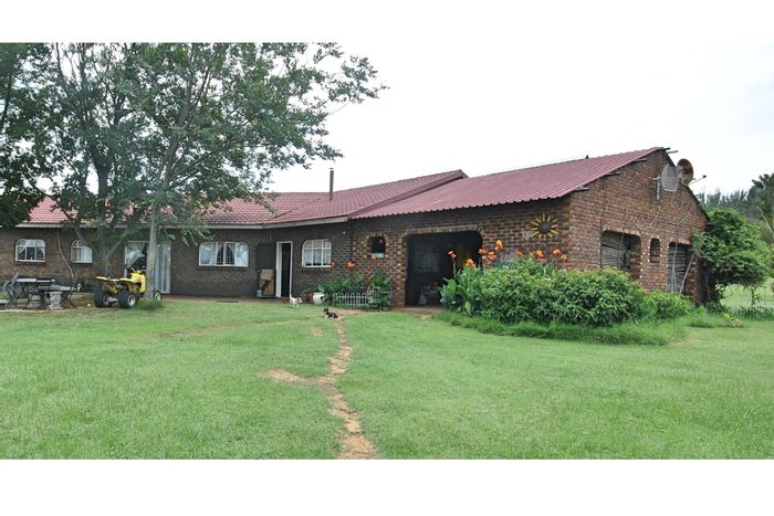 Farm for Sale in Parys Central: Multiple homes, water access, barns, and storage.