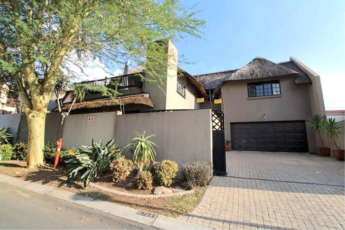 Spacious Douglasdale townhouse with pool, study, and ample parking for sale.