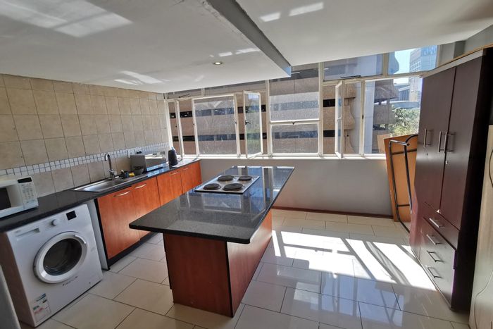 Furnished 4-bedroom apartment for sale in Braamfontein, great rental income potential.