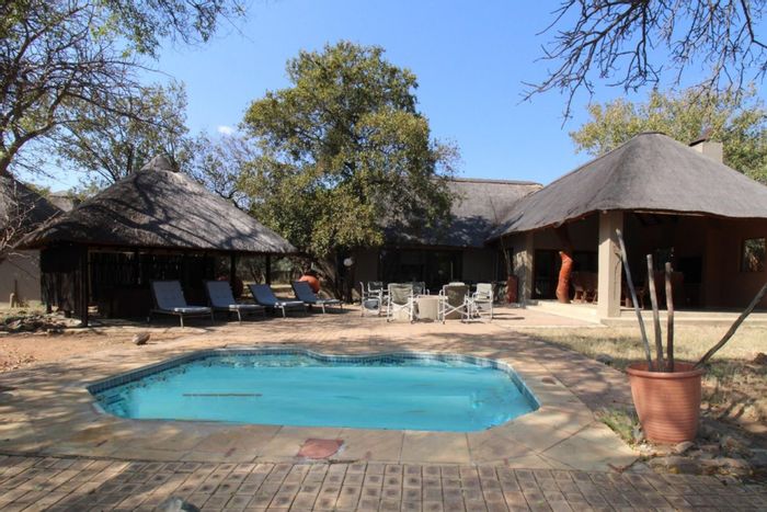 Five-bedroom house for sale at Zebula Golf Estate with pool, jacuzzi, and bar.