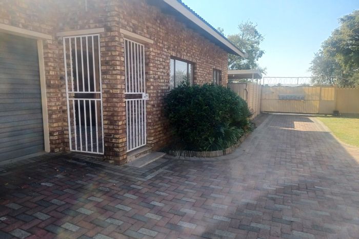 For Sale: 3 Bedroom Townhouse in Riebeeckstad with garage, carport, and security gates.