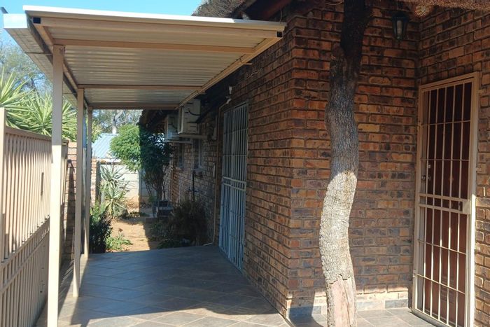 Townhouse for Sale in Hoedspruit Central: Spacious living, bar area, and air conditioning.