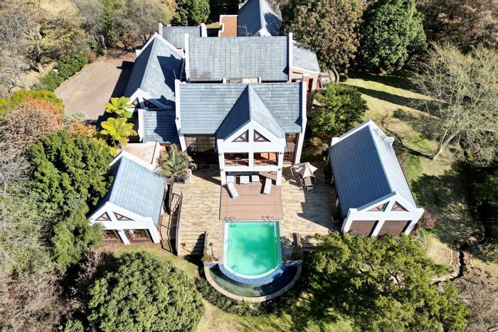 For Sale: House in Mooikloof Equestrian Estate with tennis court, pool, and stables.