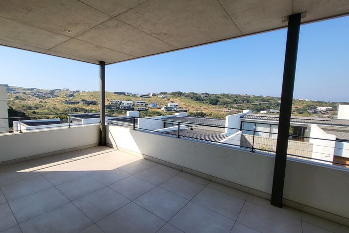 Ballito Central Townhouse For Sale: Spacious with balcony, garden, and estate amenities.