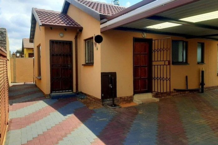 House for sale in Soshanguve Ext with paved yard and 100% bond approval.