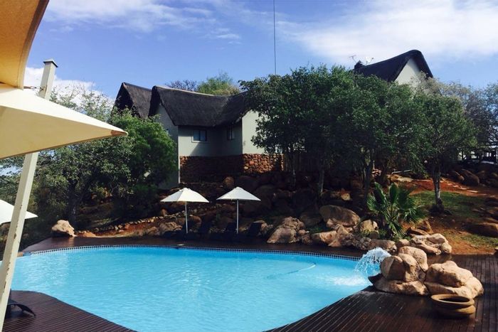 Lodge for Sale in Thabazimbi Rural: Game farm, private chalets, solar power, and amenities.