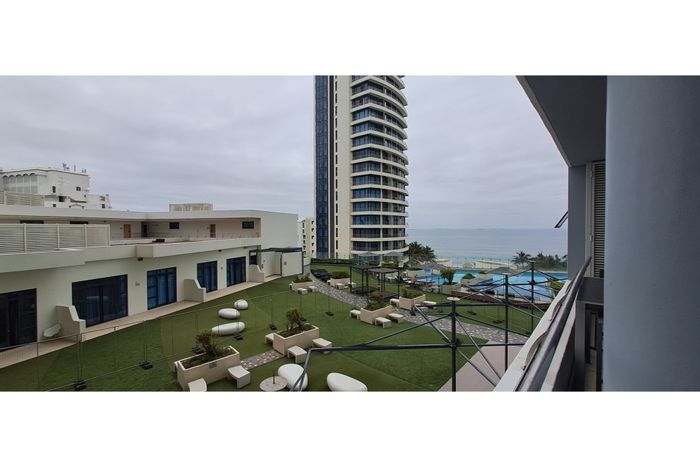 Umhlanga Central Apartment For Sale: Open-plan living, parking, near beaches and amenities.