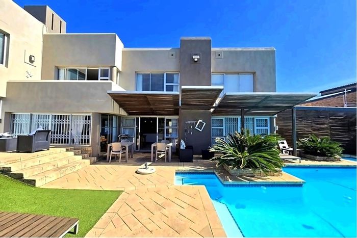 Beachfront House For Sale in Jeffreys Bay Central with pool, flat, and sea views.