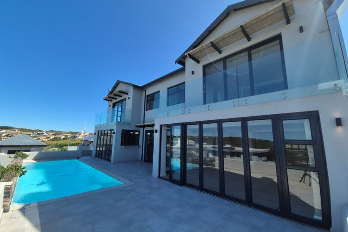 Robberg Ridge House For Sale: Secure estate, panoramic views, pool, chef's kitchen.