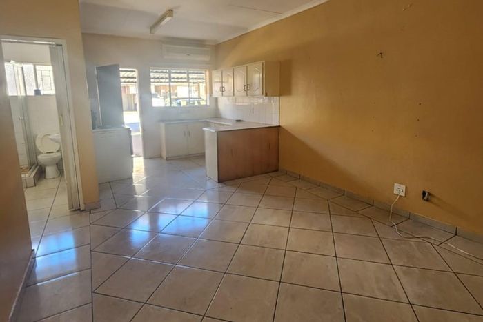 Two Bedroom Apartment To Rent in Rustenburg Central, includes water, parking, and courtyard.