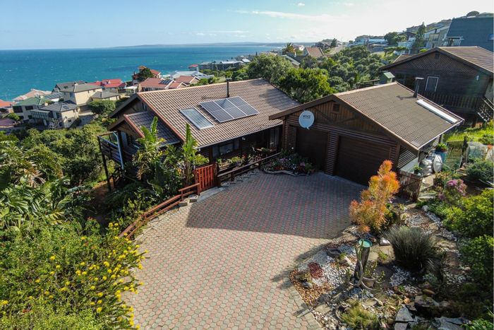 House for Sale in Dana Bay: Sea views, wrap-around deck, spacious garden, double garage.