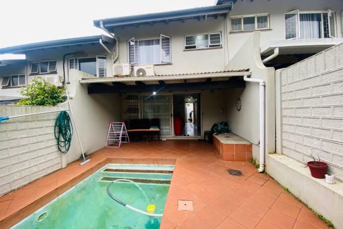 For Sale: Westridge Townhouse with pool, parking, storage, and high rental potential.