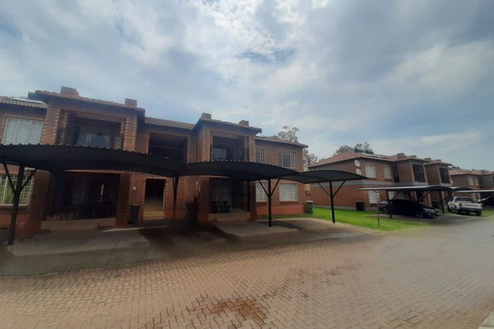 Three-bedroom apartment in Waterval East, with pool, balcony, and carport. To Rent.