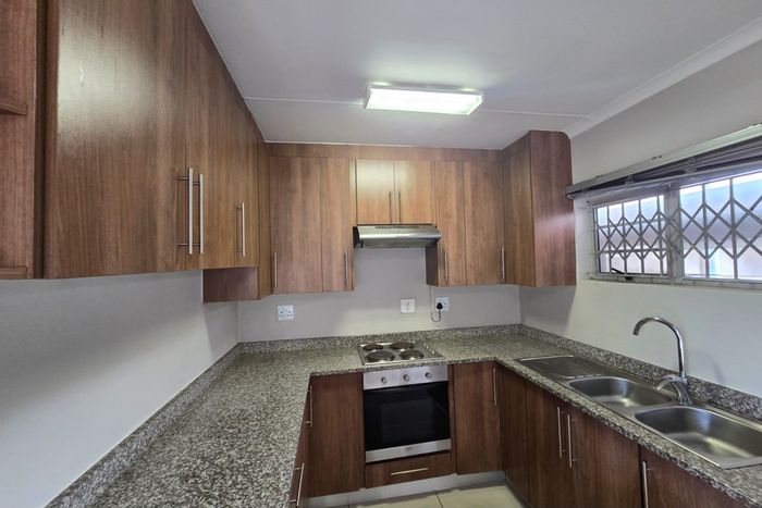 Duplex Apartment To Rent in Arboretum with spacious living, covered patio, and balcony.