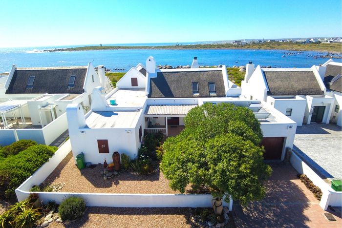 Beachfront house in Jacobsbaai for sale: 4 bedrooms, office, patio, garage.