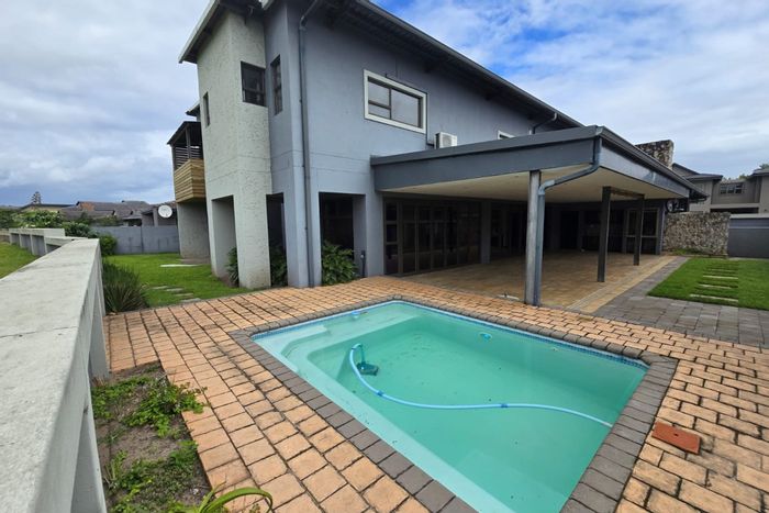 For Sale: House in Mzingazi Golf Estate with 3 garages, pool, and solar power.