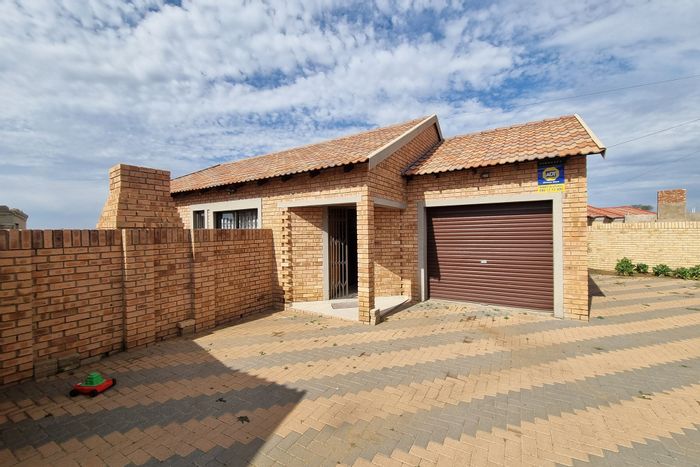 For Sale: Townhouse in Meiringspark with garage, garden, and built-in braai.