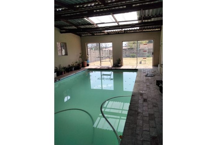 House for Sale in Bethal Central: Indoor heated pool, study, 3-car garage.