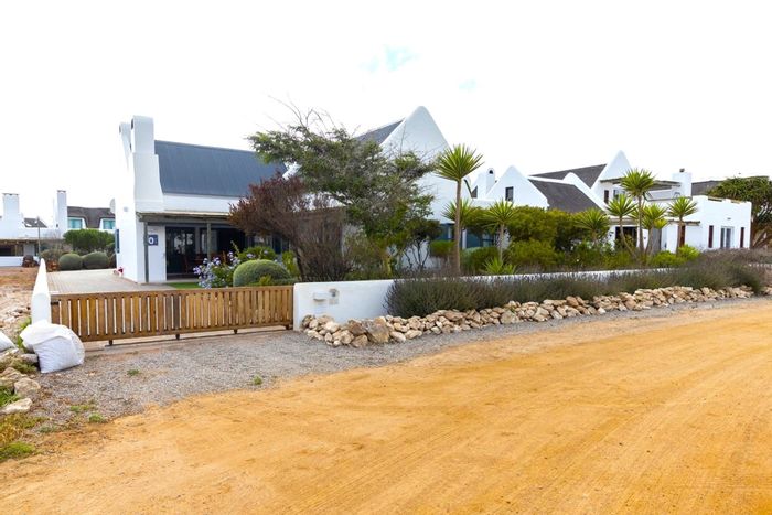 House for Sale in Jacobsbaai: Sea views, garden, braai area, and double garage.