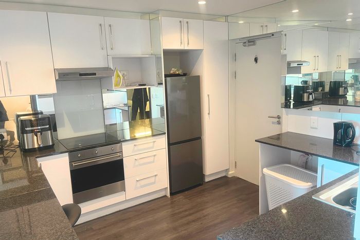 For Sale: 2-bedroom apartment in Woodstock with gym, rooftop pools, and retail access.