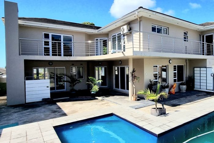 For Sale: 4-Bedroom House in Beacon Bay with pool, bar, and sports amenities.