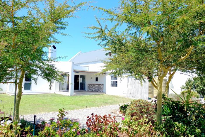 House for Sale in Jacobsbaai: 3 Bedrooms, gardens, garages, eco-friendly features.