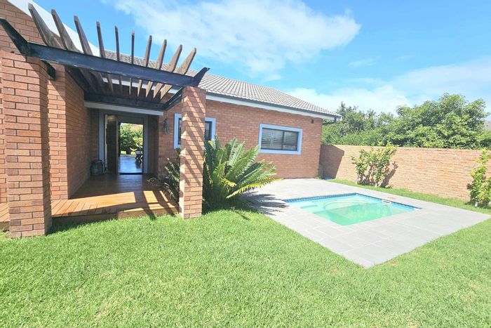 Coastal house for sale in Paradise Beach: pool, garden, and beach access.