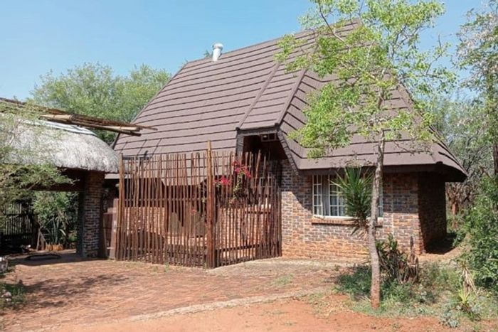 Marloth Park Central House For Sale: Guest house with lookout tower, jacuzzi, and wildlife views.