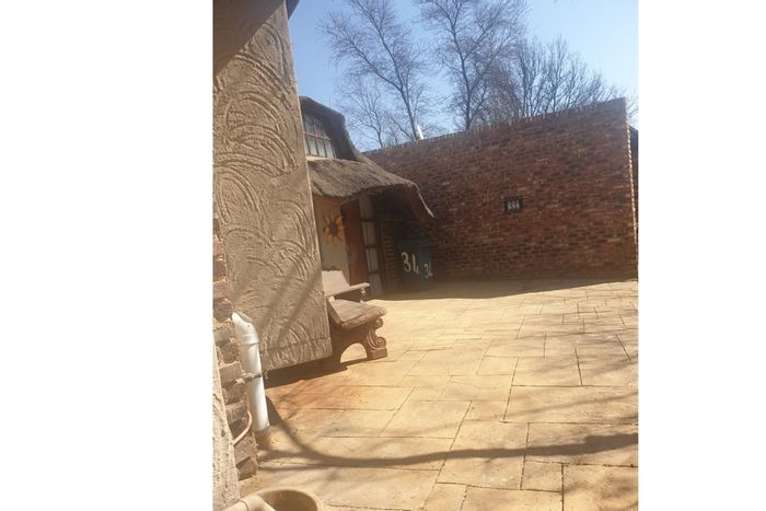 For Sale: 4-bedroom house in Orkney Rural with garden, garage, and braai pit.