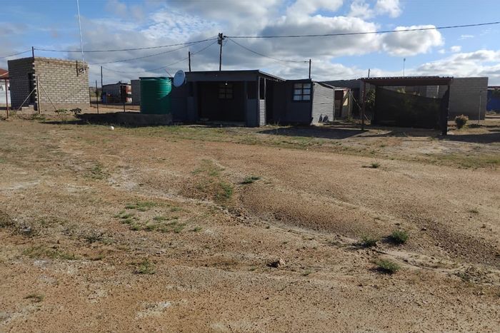 Moletji House For Sale: 3-room tin house, electricity, carport, and Jojo tank.
