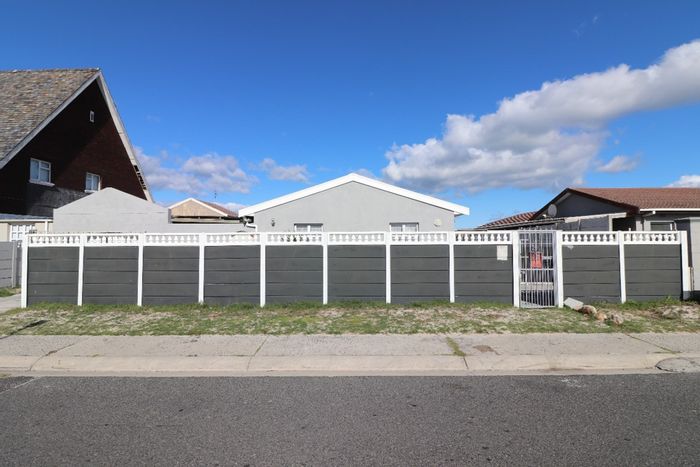 For Sale: Spacious 4-bedroom house in Strandfontein with dual living potential and ample parking.