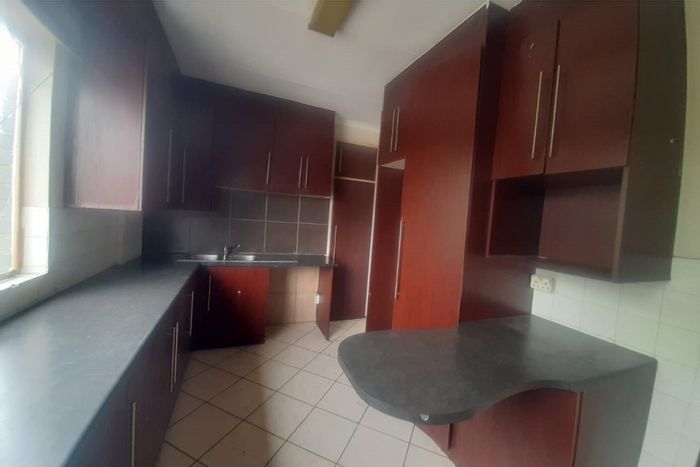 Two-bedroom apartment to rent in Rustenburg Central, secure complex, water included.