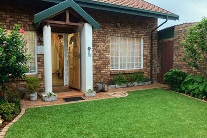 For Sale: Clubview Townhouse with private garden, communal pool, and double garage.