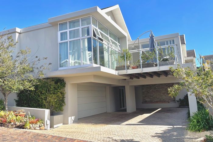 For Sale: Bowtie House with spacious living, gourmet kitchen, steam room, and sea view.