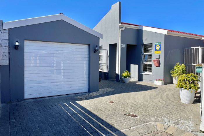 For Sale: 4-Bedroom House in Strandfontein with garage, yard, and security features.