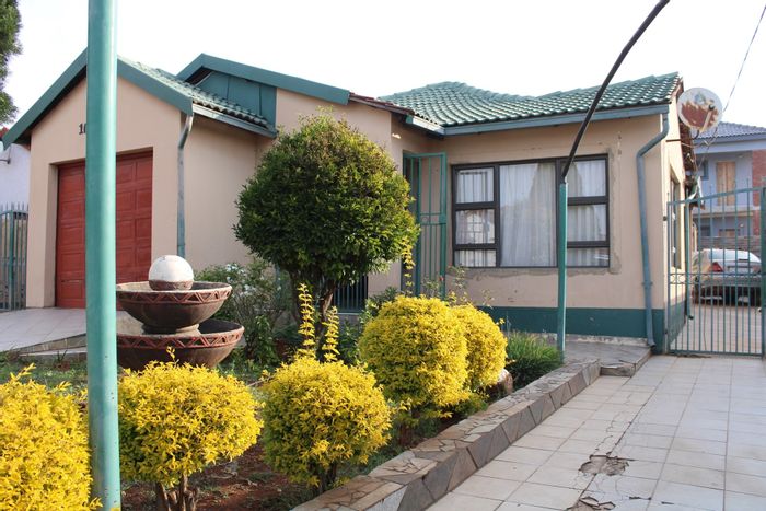 For Sale: House in Lotus Gardens with 3 bedrooms, garage, and outdoor space.
