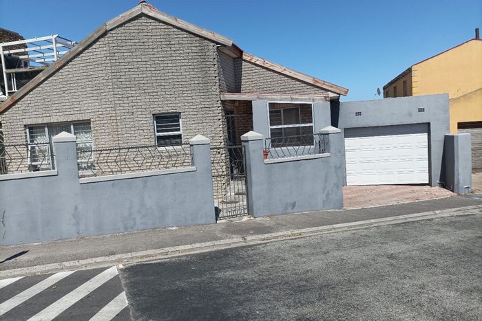 For Sale: Spacious Strandfontein house with 4 bedrooms, garage, and investment potential.