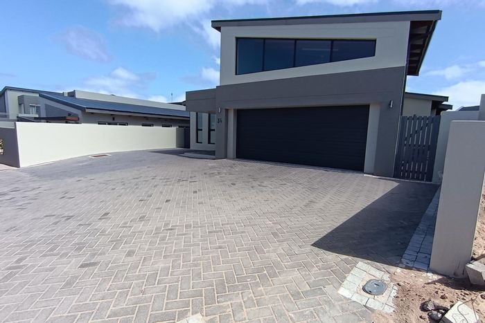 Coastal townhouse in Sunset Estate for sale: beach access, ample parking, and outdoor space.