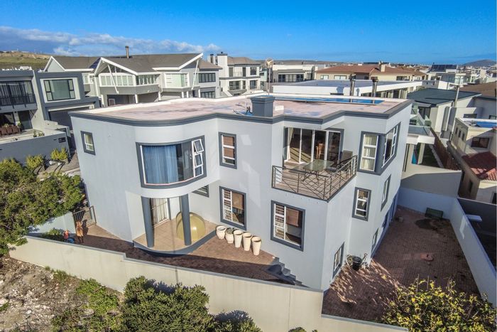 For Sale: Calypso Beach House with lagoon views, entertainment room, and private beach access.