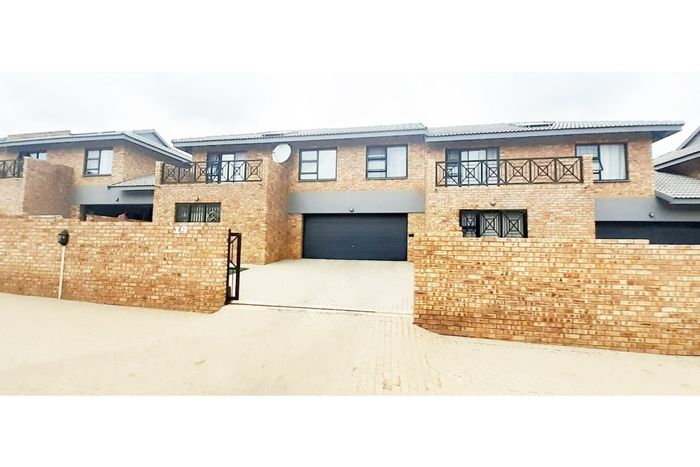 For Sale: Ruimsig Townhouse with 4 beds, pool, garage, and rental income potential.