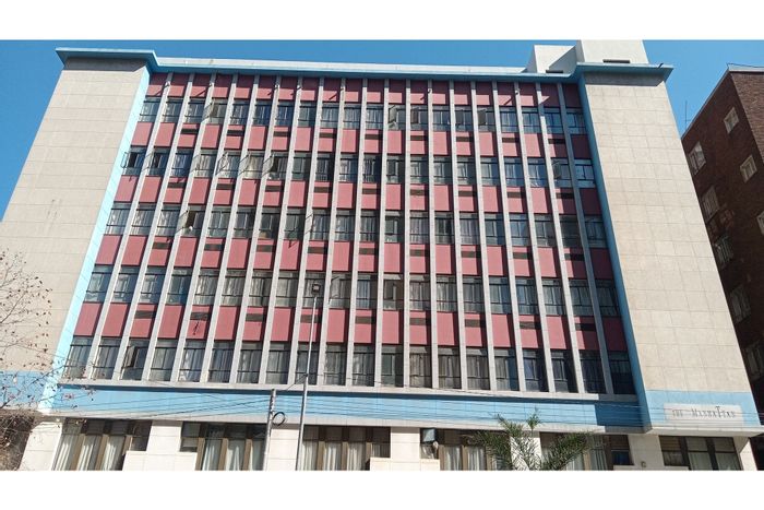 For Sale: Braamfontein Apartment with rental income, fitted kitchen, prepaid utilities.