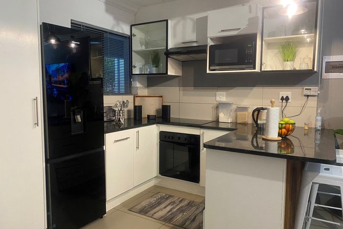 1-Bedroom Apartment in Fourways To Rent, featuring backyard, kitchen, and dual bathroom.
