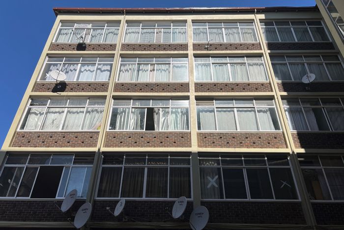 Spacious bachelor apartment in Sunnyside with private kitchen, bathroom, and parking. For Sale.