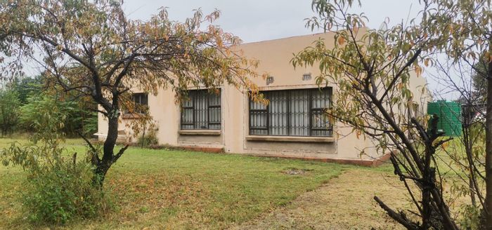 Versatile house for sale in Walker Fruit Farms with multiple structures and ample space.