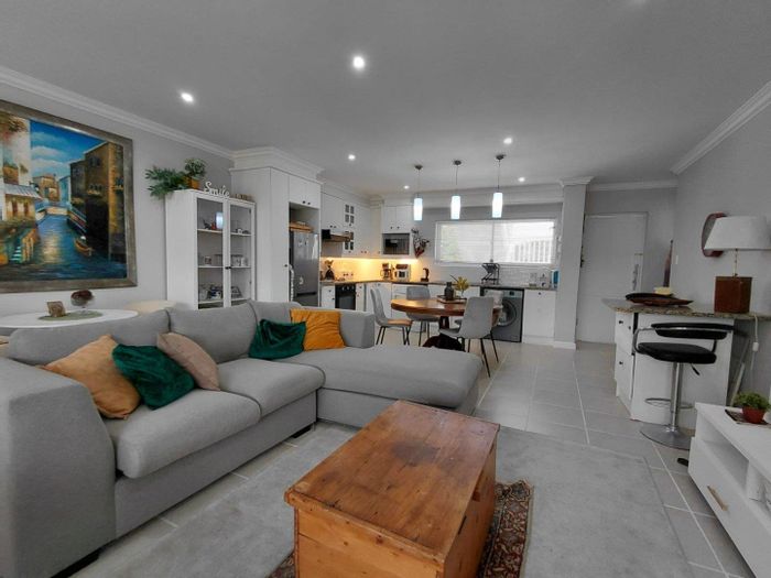 Canal-side apartment for sale in Marina Martinique with boat mooring and balcony.