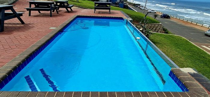 Beachfront House For Sale in Umdloti Beach with spa, flat, pool, and garage.