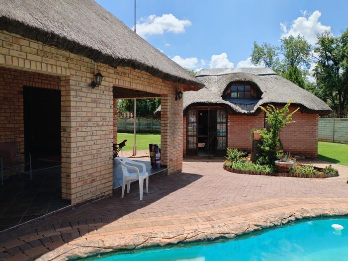 Spacious 5-bedroom house with pool, garages, and security in Stilfontein Central For Sale.