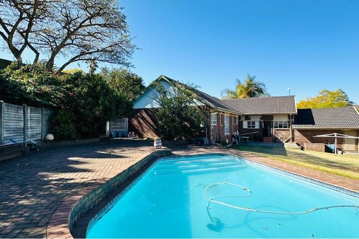 For Sale: Spacious Signal Hill Apartment with pool, garages, and home office.